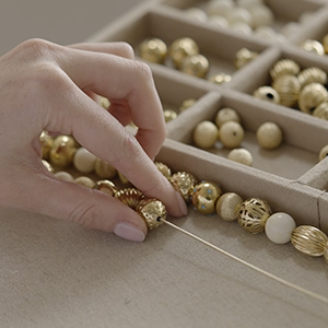 Stringing pearls and sticking rhinestones